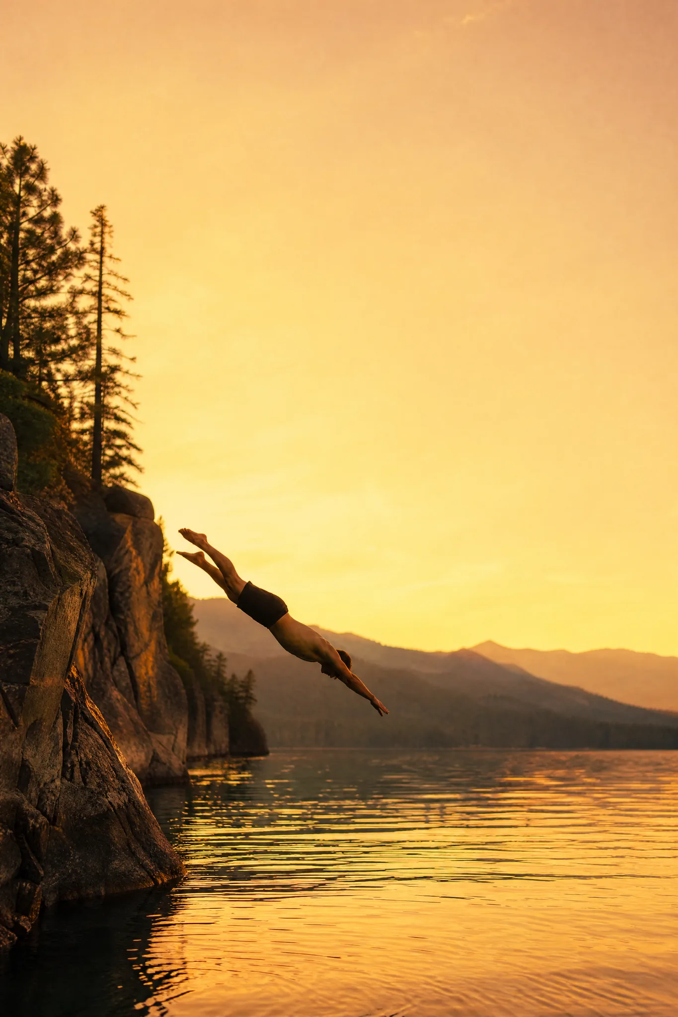 Grok Imagine Image 2: Planned for Its Layout Cliff diver mid-dive toward a golden lake at sunset with wide open sky above